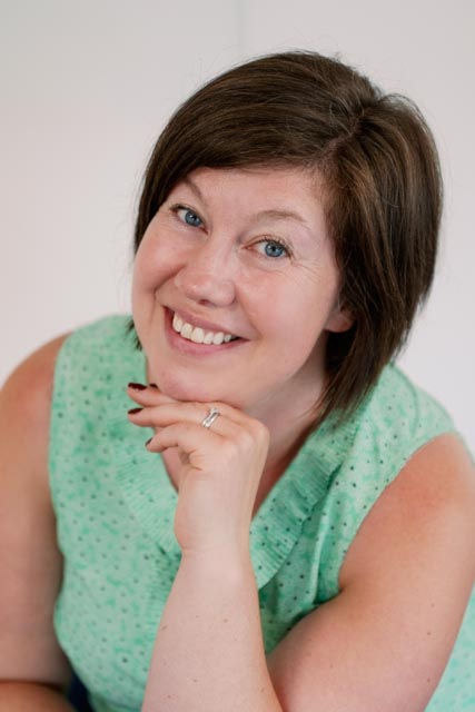 Beshlie Donaldson smiling, resting her chin on her hand