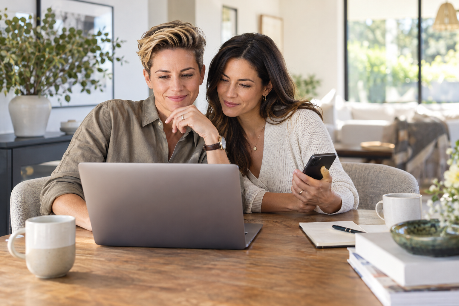 A couple preparing together with a laptop and phone before visiting the dealership