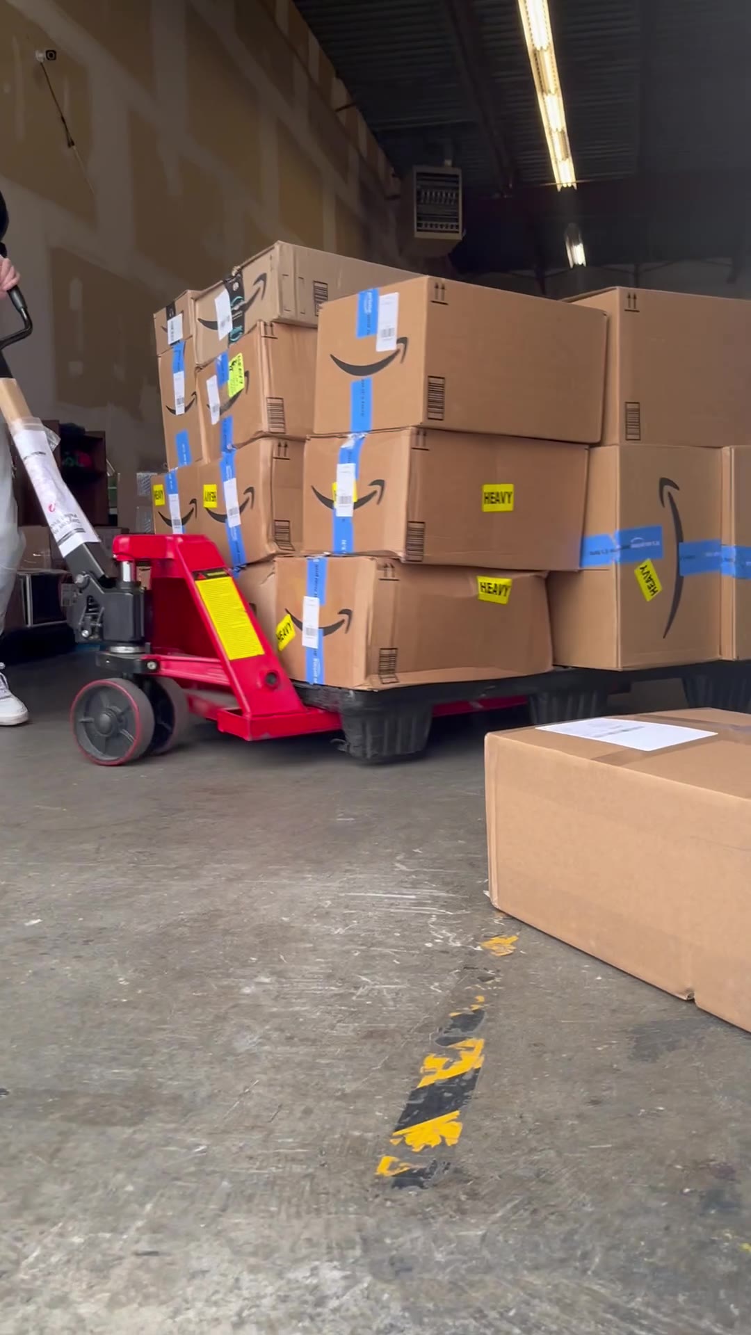 Pallets of stock on a pallet jack in the warehouse