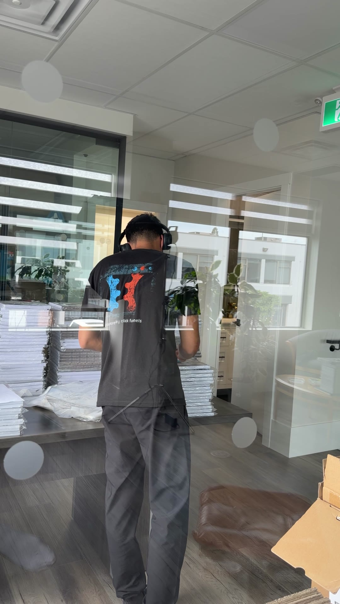 Ali handling stock and paperwork in the Vela K office