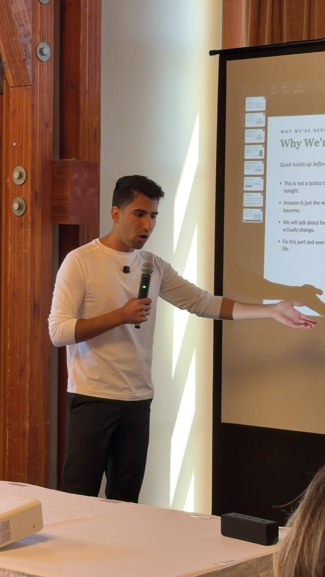 Ali speaking with a microphone at a Vela K event