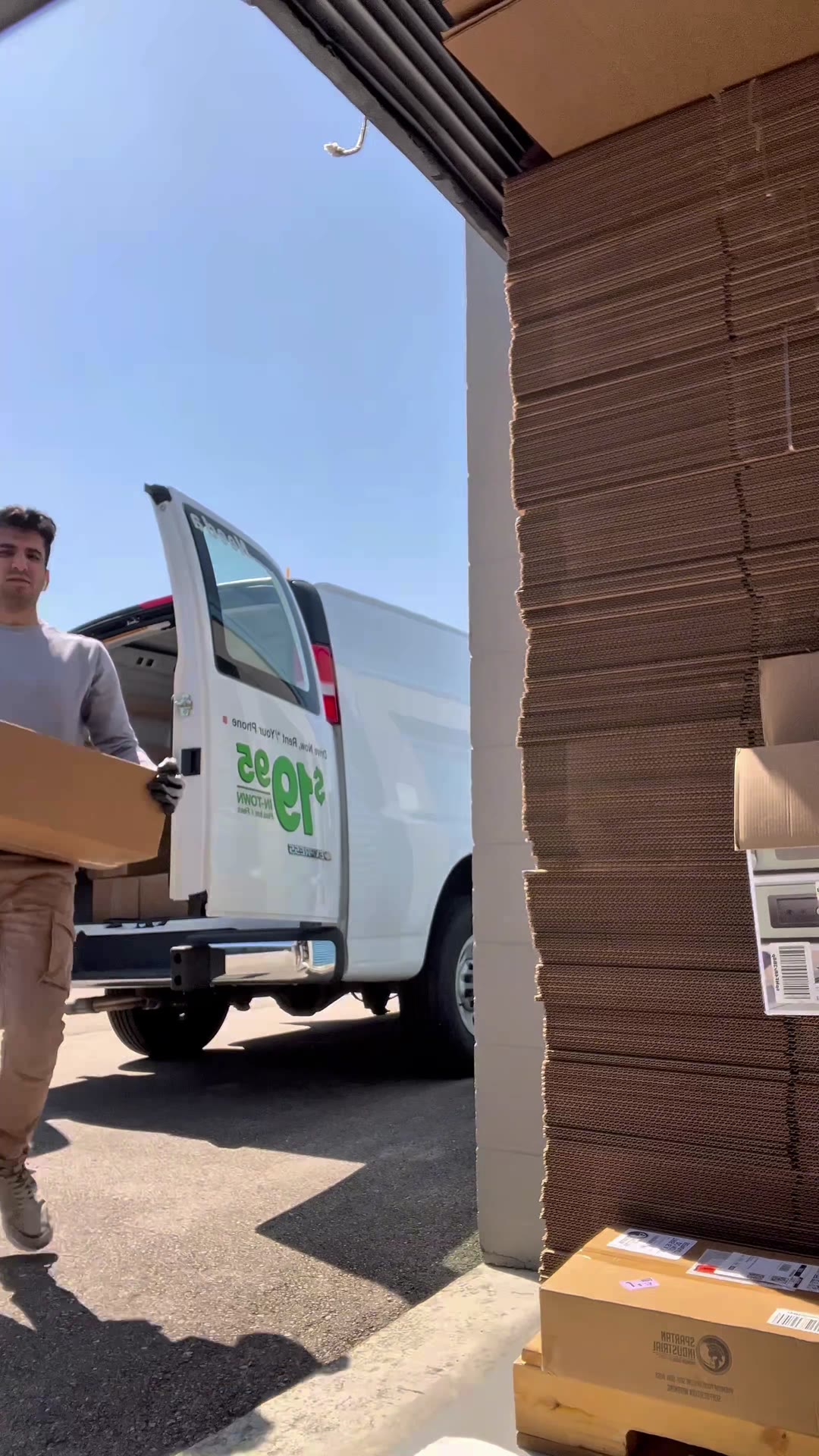 Ali loading boxes into a van