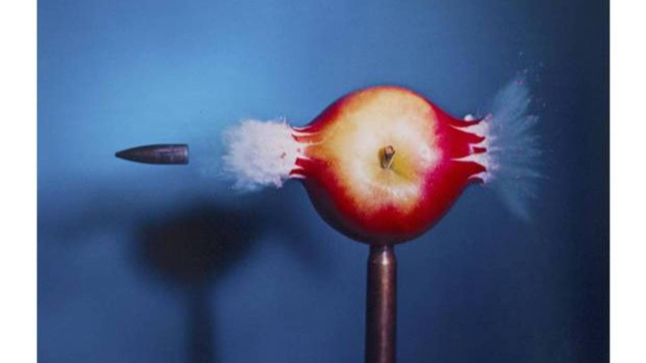 Doc Edgerton stroboscopic photo of a bullet passing through an apple