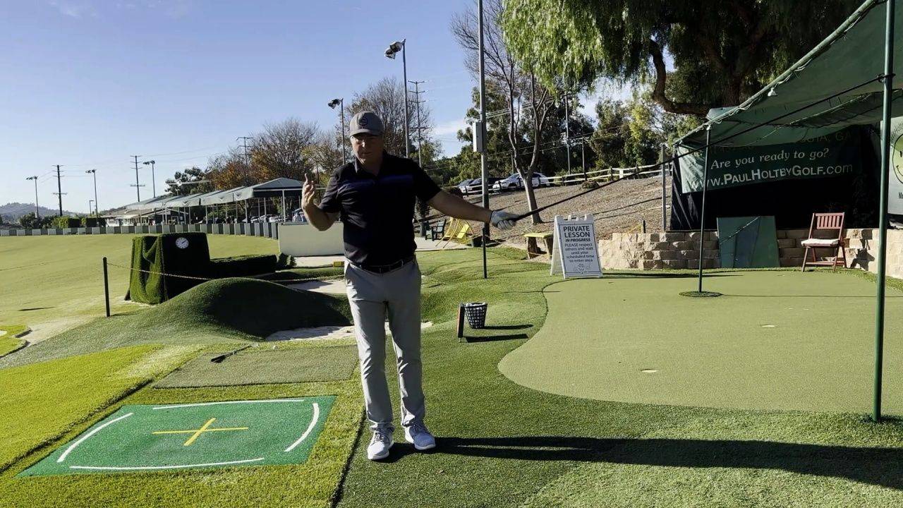 Golfer hitting a Brooks Koepka style power fade drive at the driving range