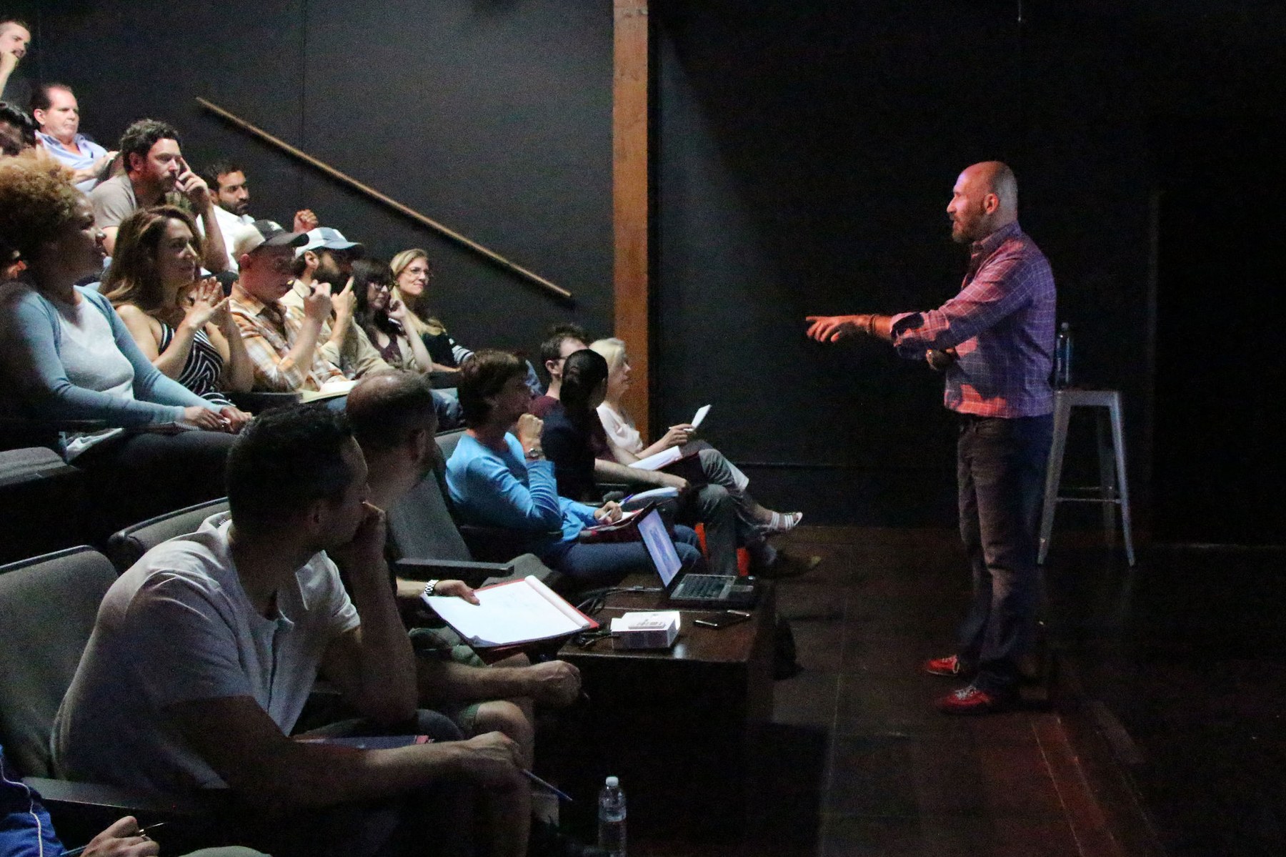 John teaching a class in a dark theater