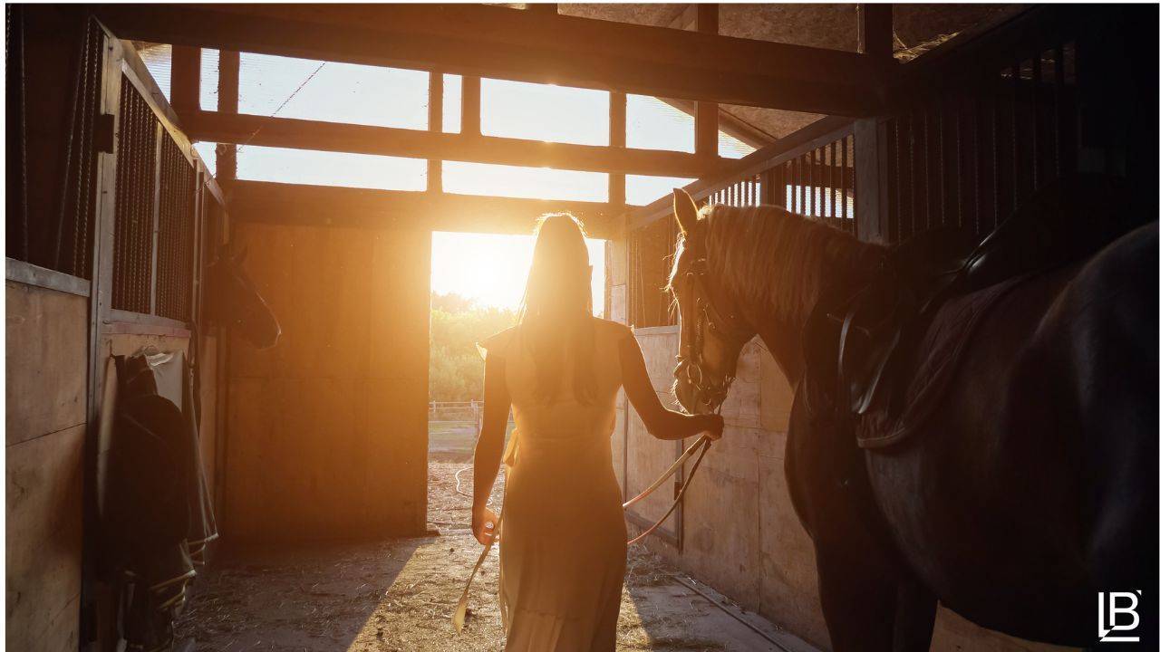 Woman in barn with horse