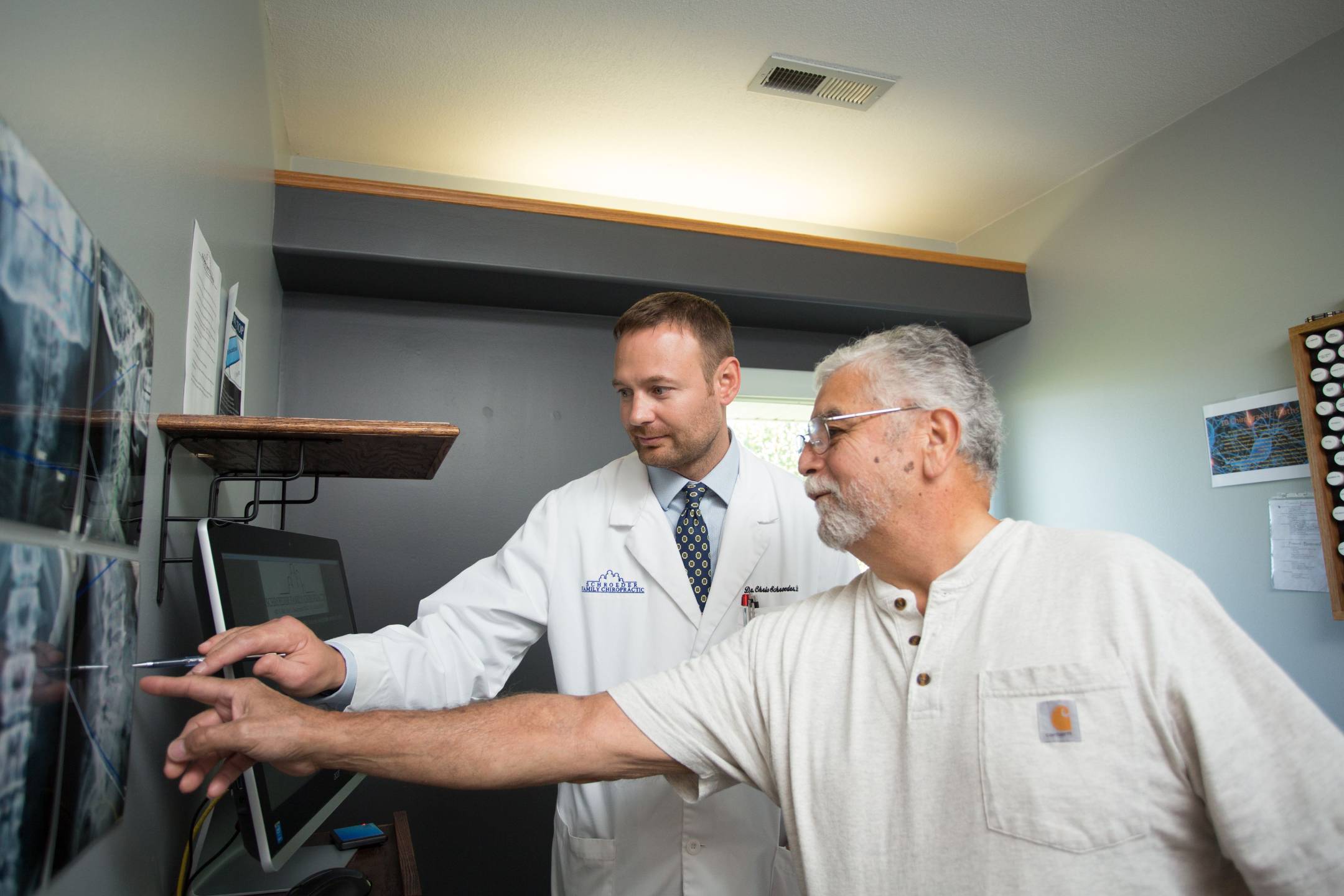 Chiropractor reviewing back x-rays with a patient