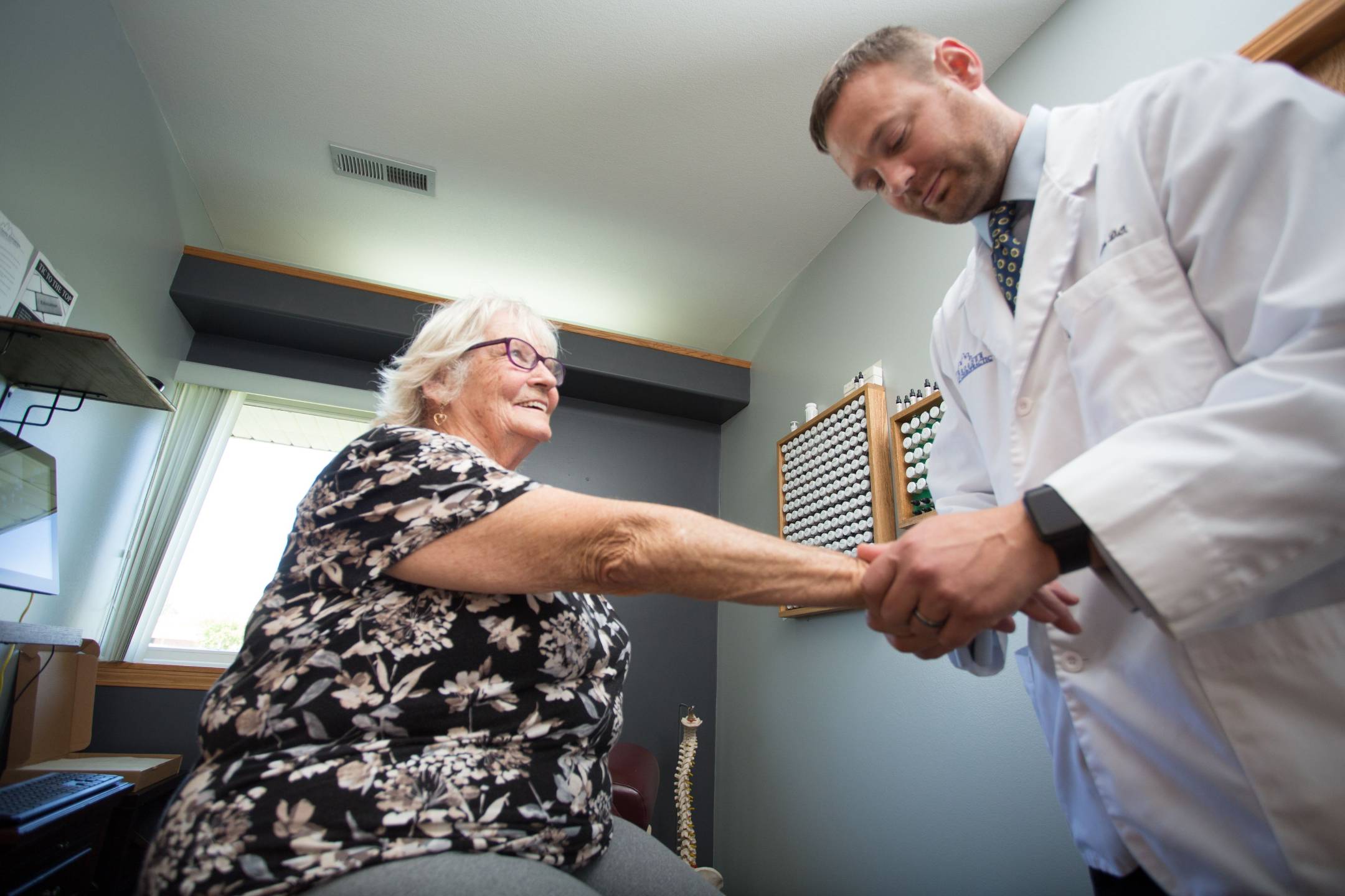 Chiropractor treating a patient's wrist for carpal tunnel relief