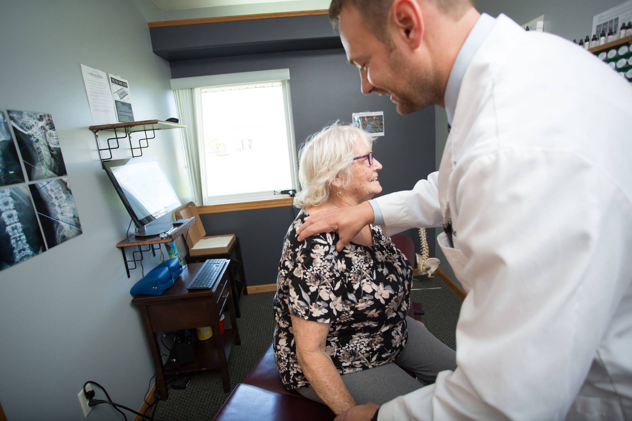 Chiropractor treating a patient's shoulder for pain relief