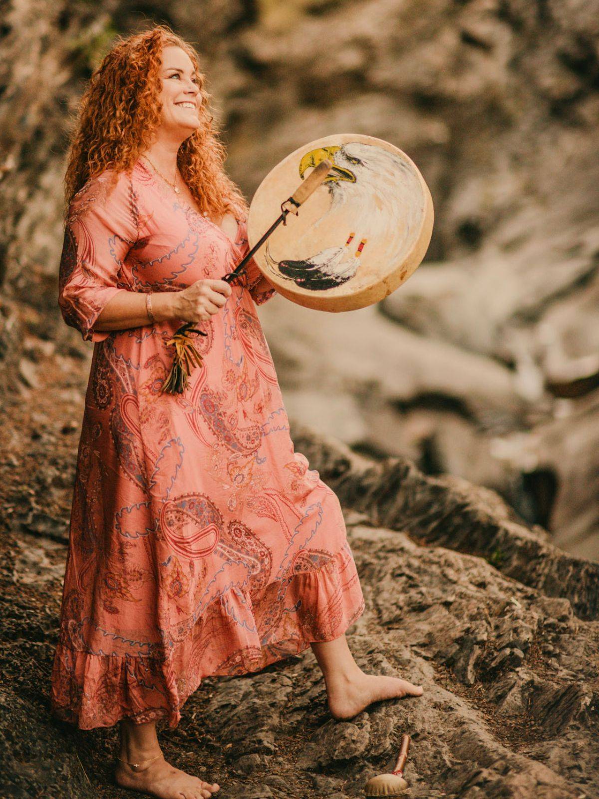 Michele Edwards outdoors with ceremonial drum