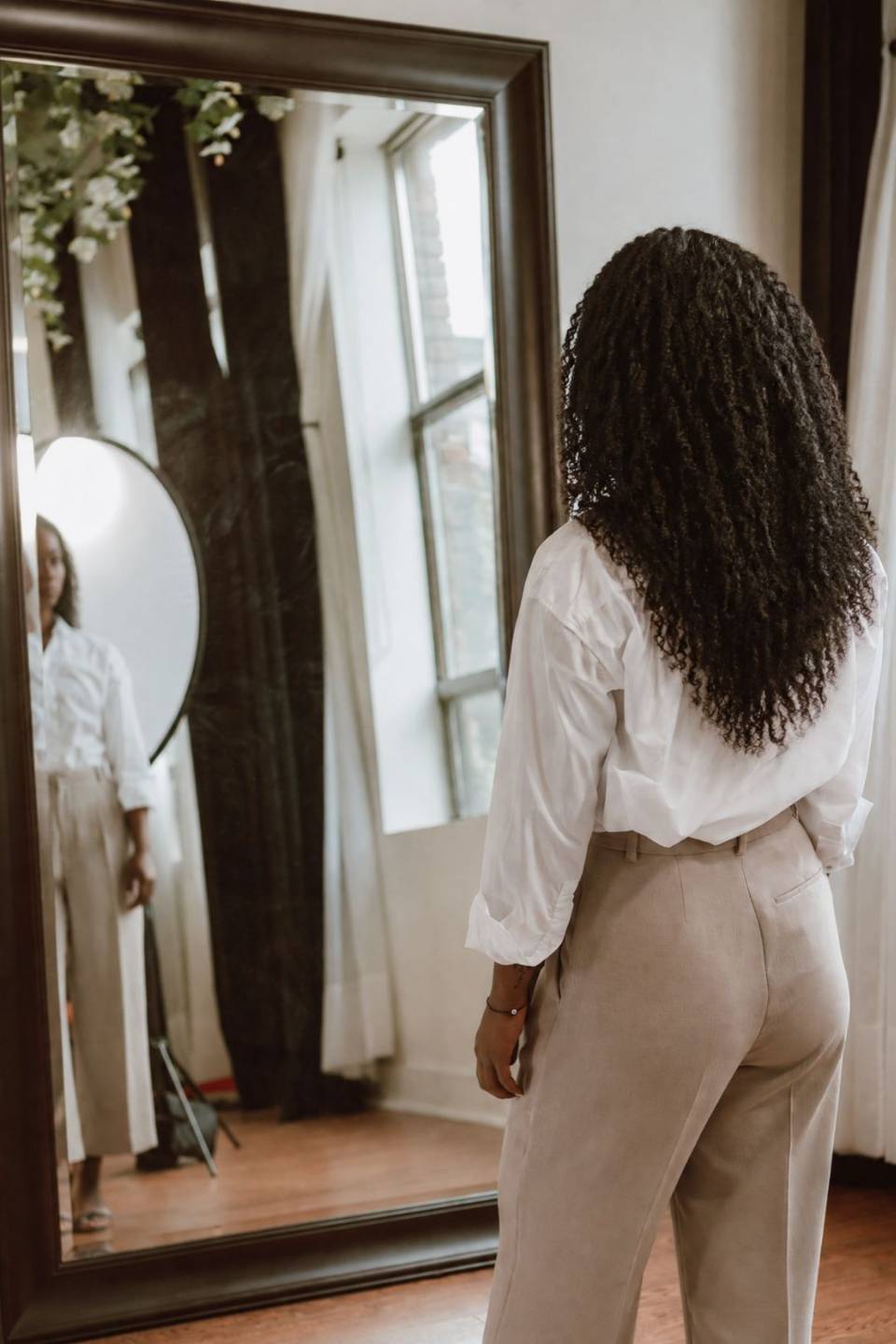 Woman looking into mirror