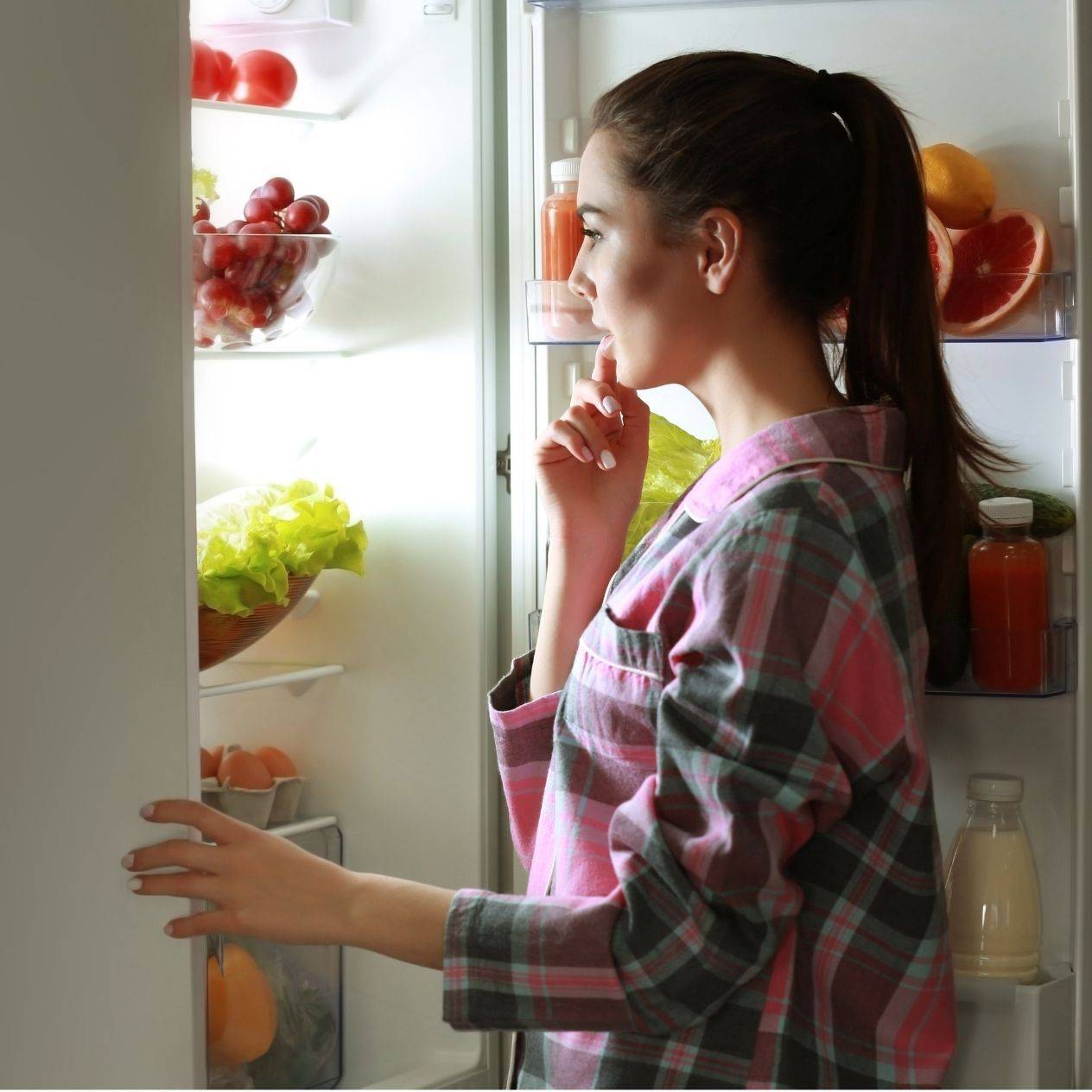 Woman looking into fridge