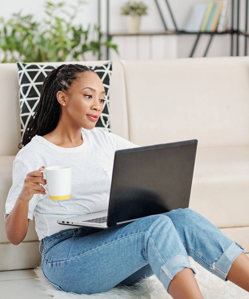 Woman with mug at laptop