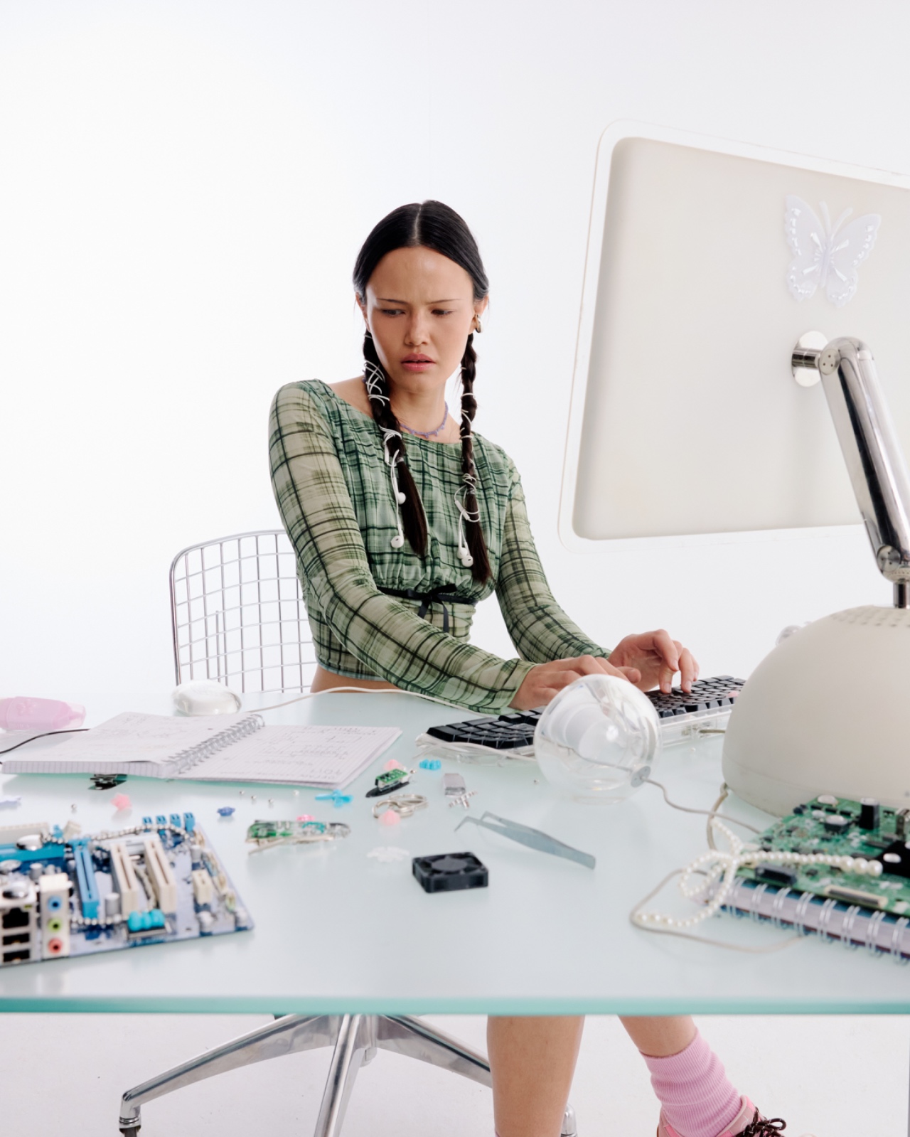 An educator working at a desk with an all-in-one computer