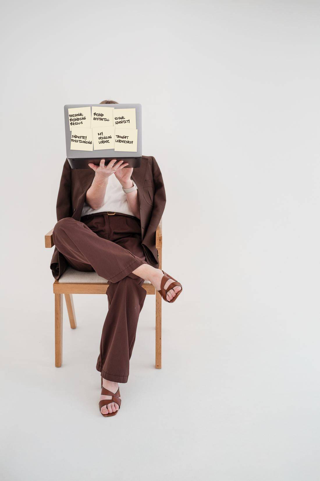 Laptop covered in sticky notes reading personal branding basics, brand aesthetic, visual identity, industry positioning, key opinion leader and thought leadership