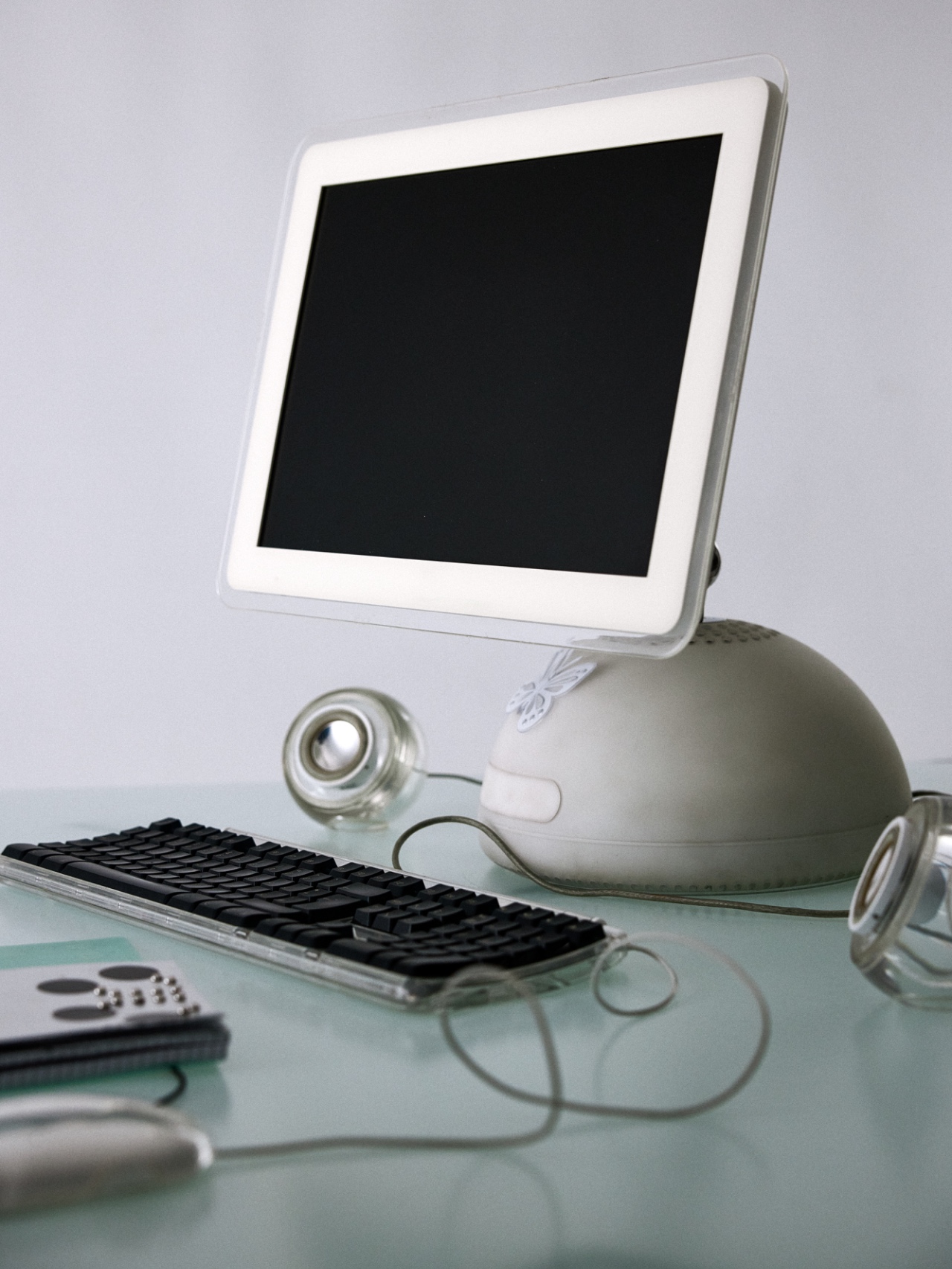 A vintage computer and keyboard on a pale desk