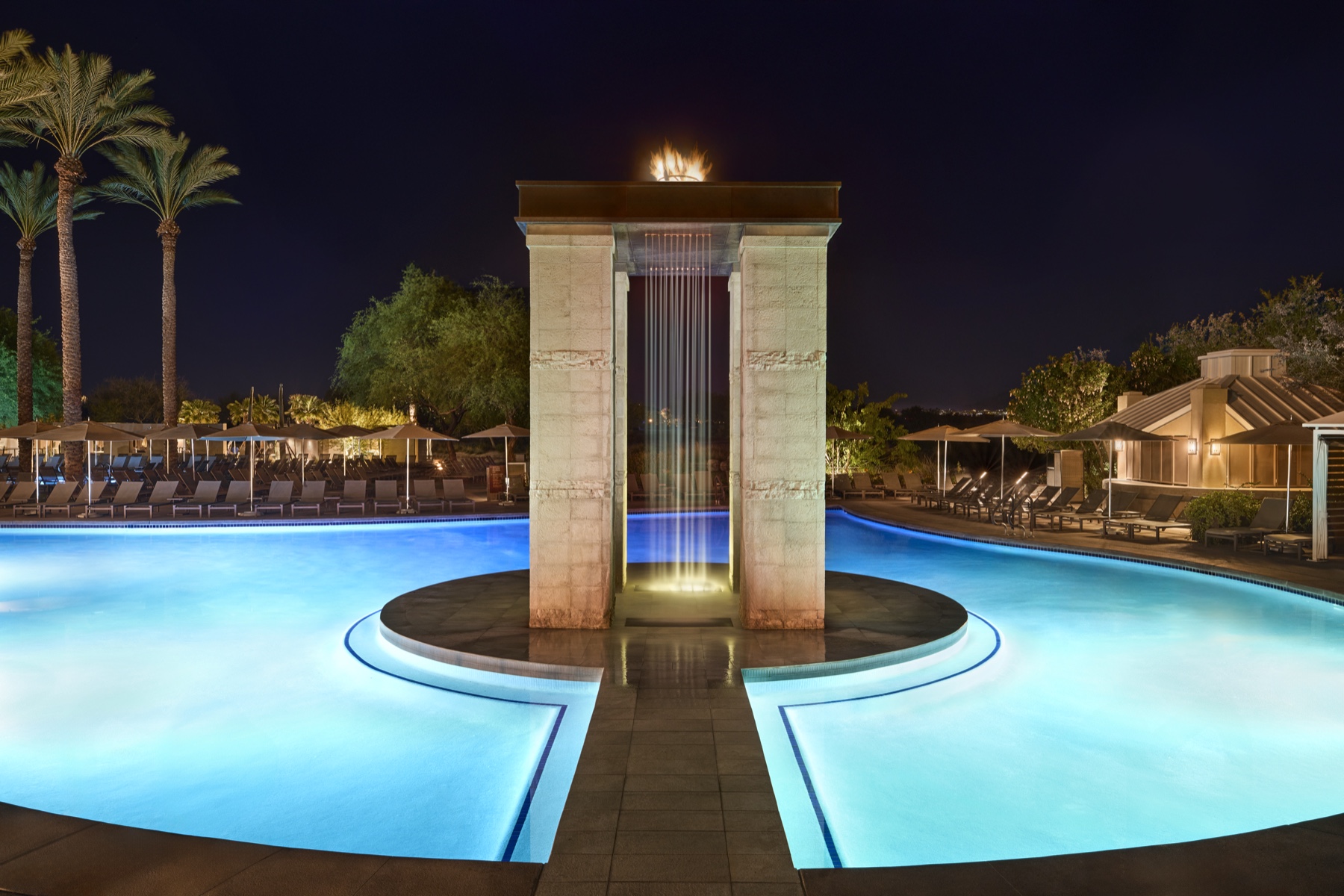 JW Marriott Phoenix Desert Ridge — Pool and fire-lit tower at night