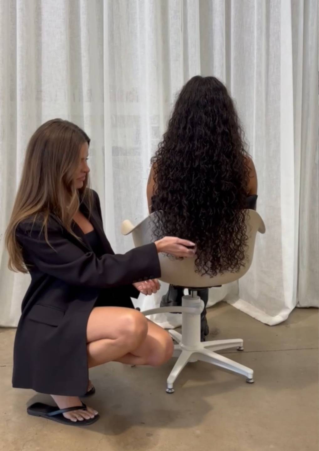 Kim Hartnett showcasing long curly keratin bond hair extensions with a natural textured blend