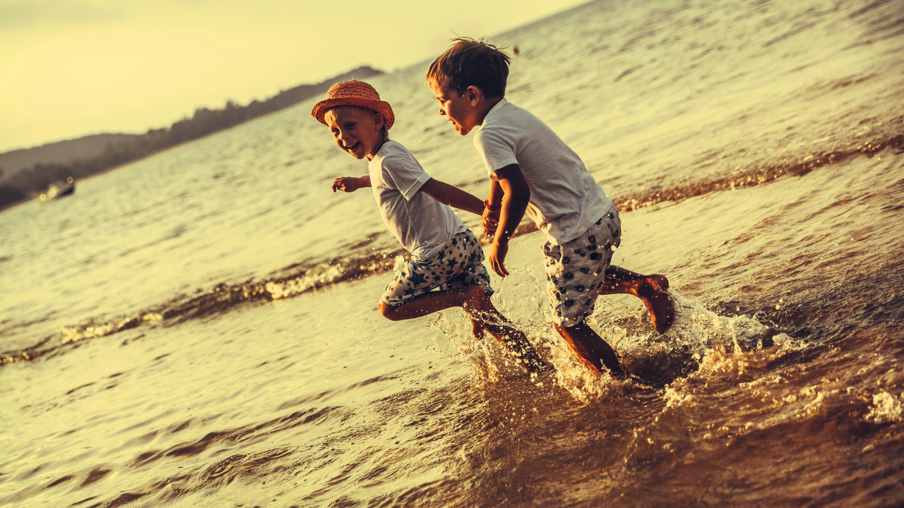 two boys playing in foreshore