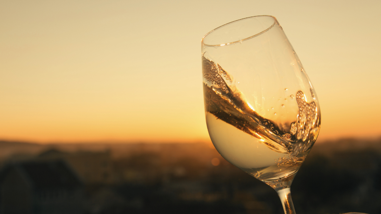 wine glass with swirling white wine