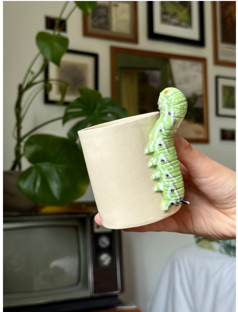 Ceramic mug with a sculpted caterpillar handle