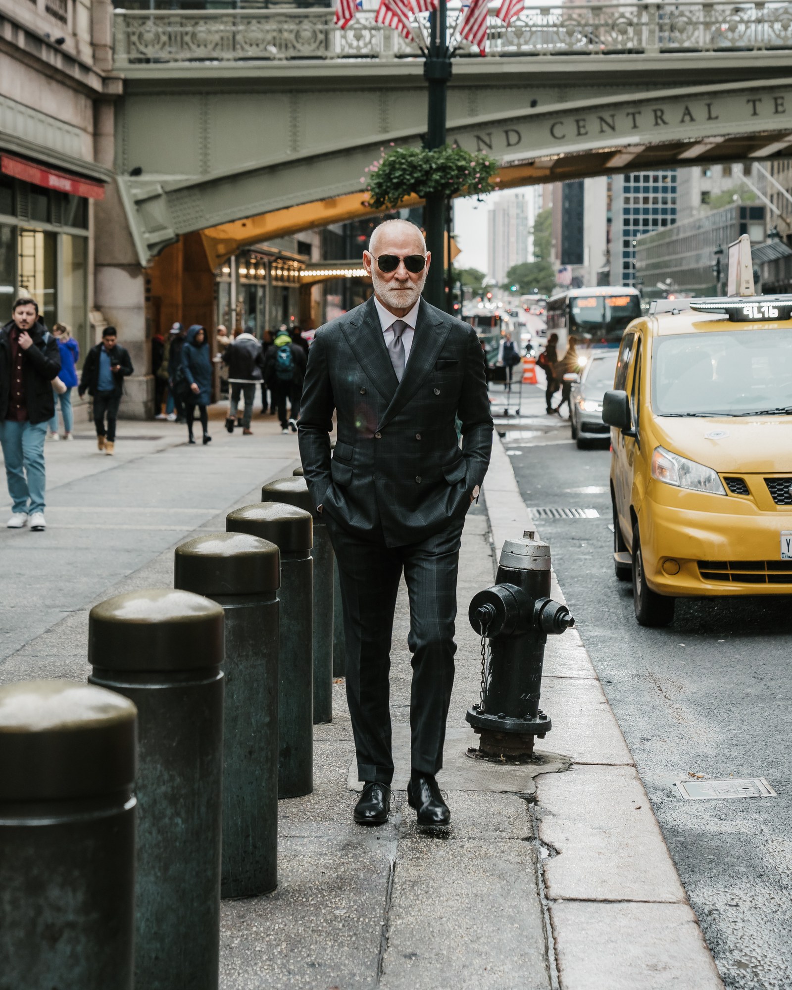 Randy Willard walking past Grand Central in New York in a double-breasted suit