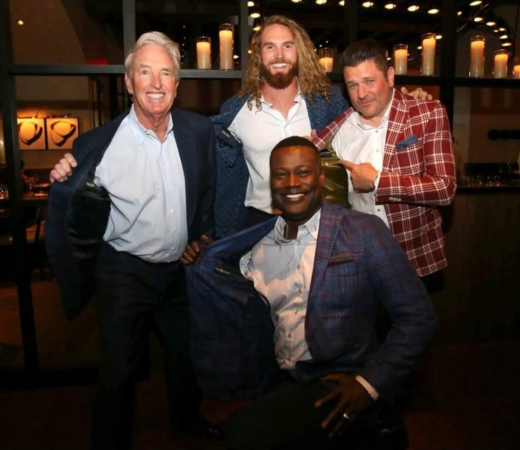 Four of Randy’s clients together at an evening event, all in tailored jackets