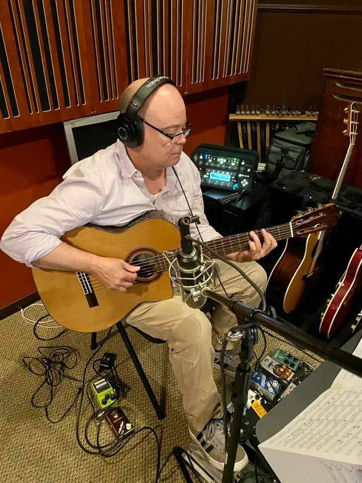 Close-up of hands playing jazz chords or melodic lines on guitar