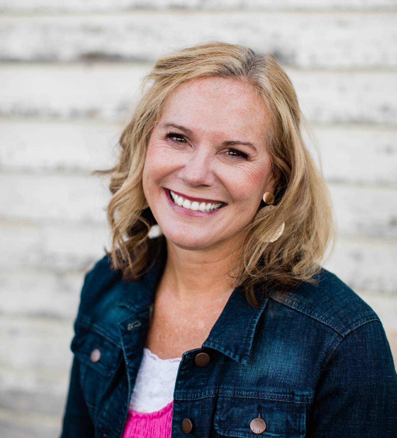 Shelly Rees, creator of the Appletastic Club, smiling in a denim jacket