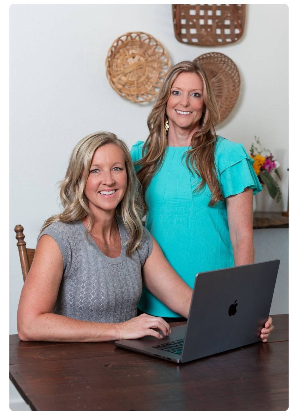 Tiana Rockwell and Erin McCarthy of The Wellness Academy working together at a laptop