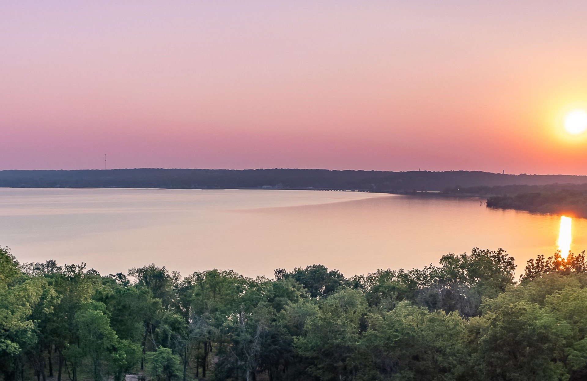 A wide lake at sunset seen from above