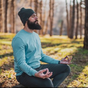 Man meditating by the water