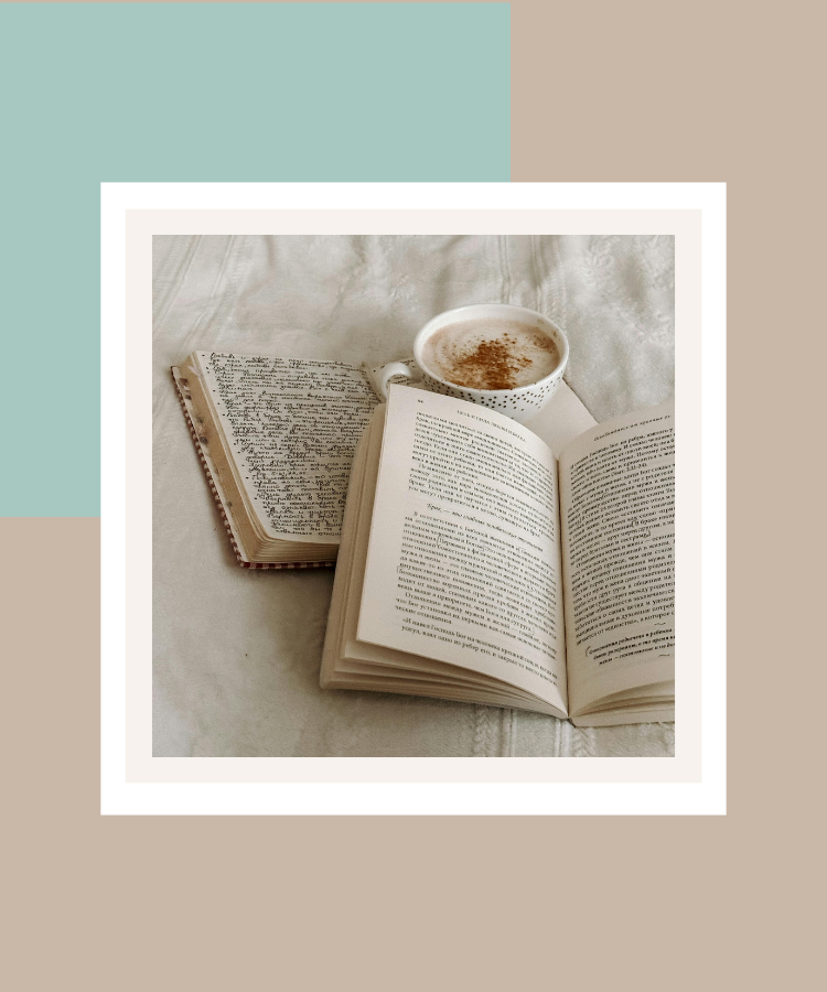 An open book, handwritten journal and warm cup of coffee resting on soft cream fabric, creating a cosy moment of quiet reflection, framed against a sage green and beige background.