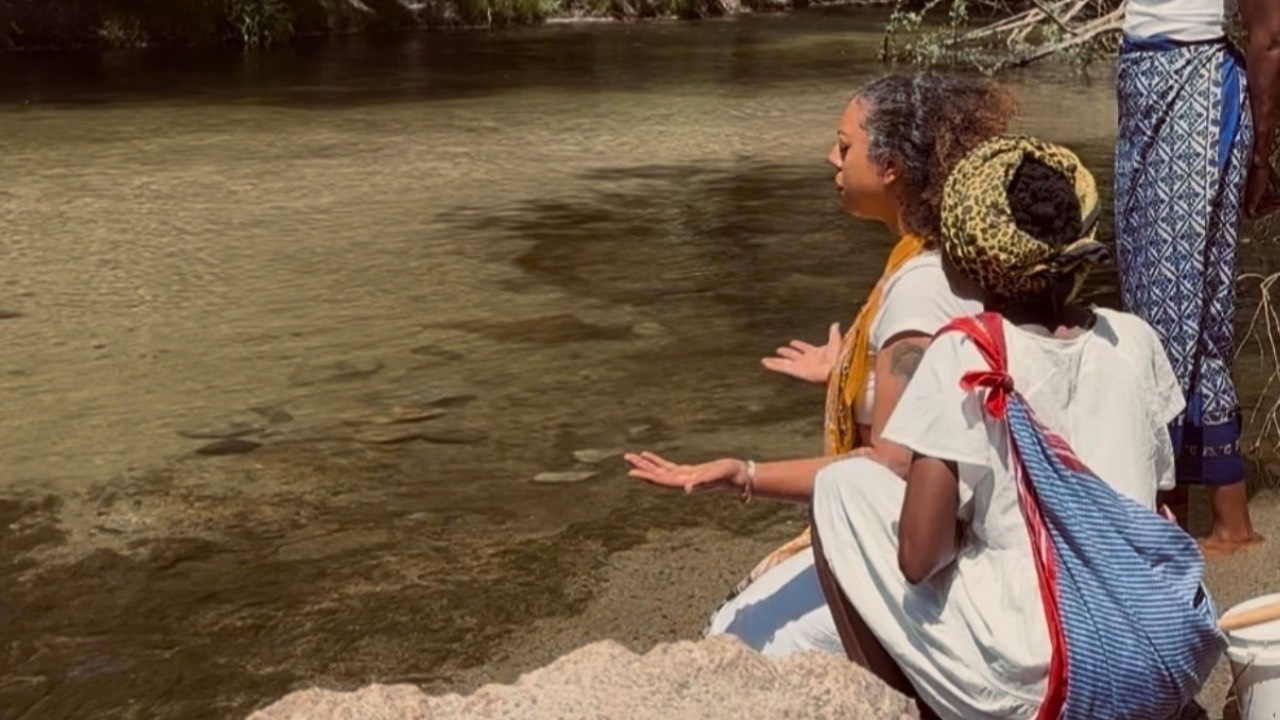 Hands open over the river