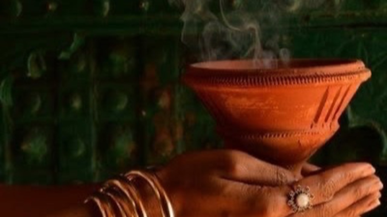 Smoke rising from a clay bowl