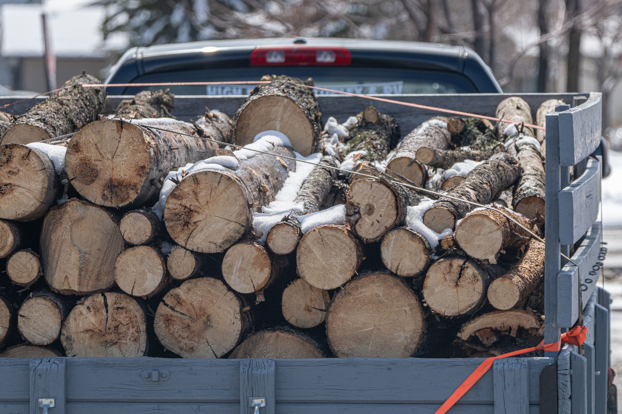 A trailer stacked high with split birch logs