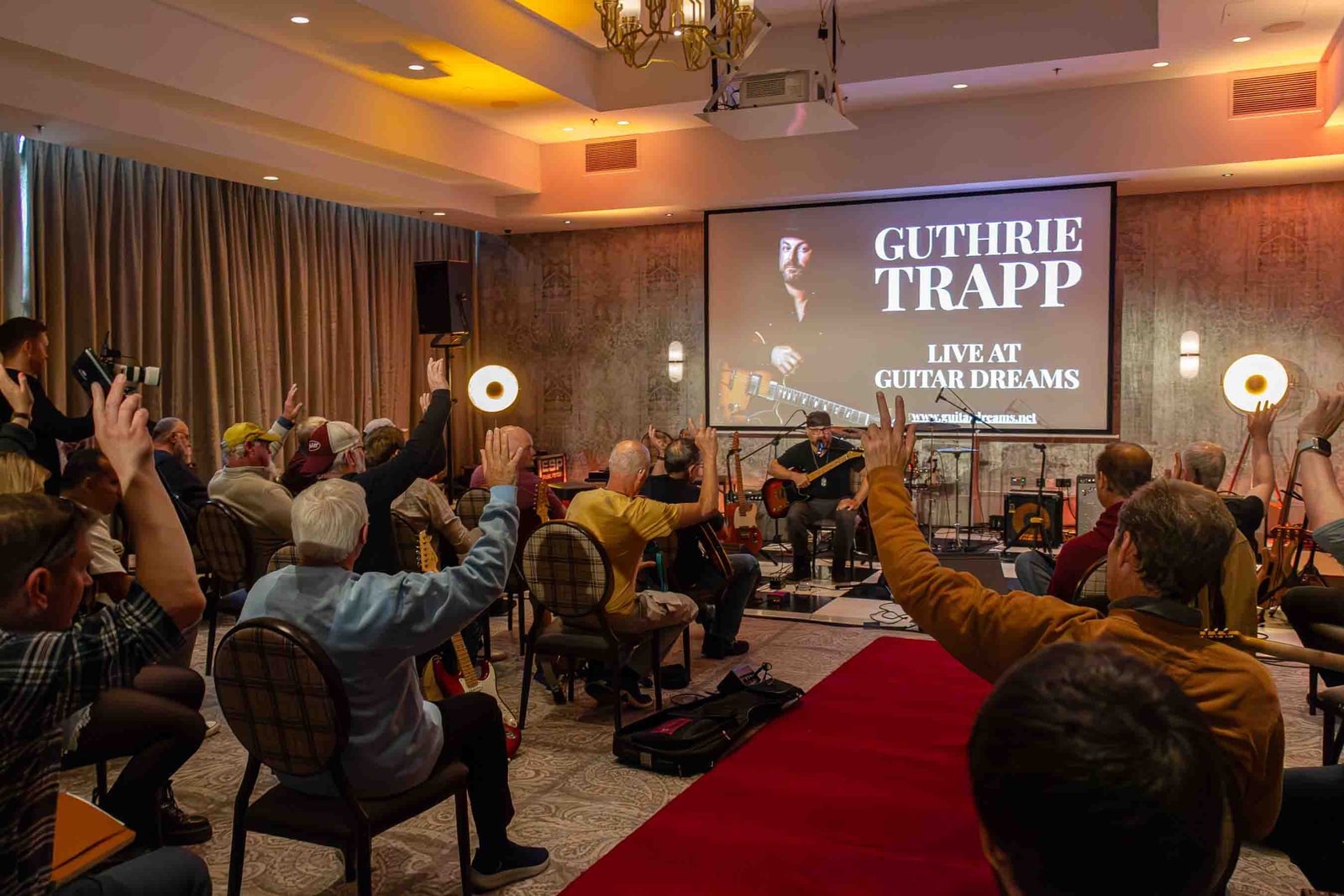 A full room raising hands during Guthrie Trapp's session