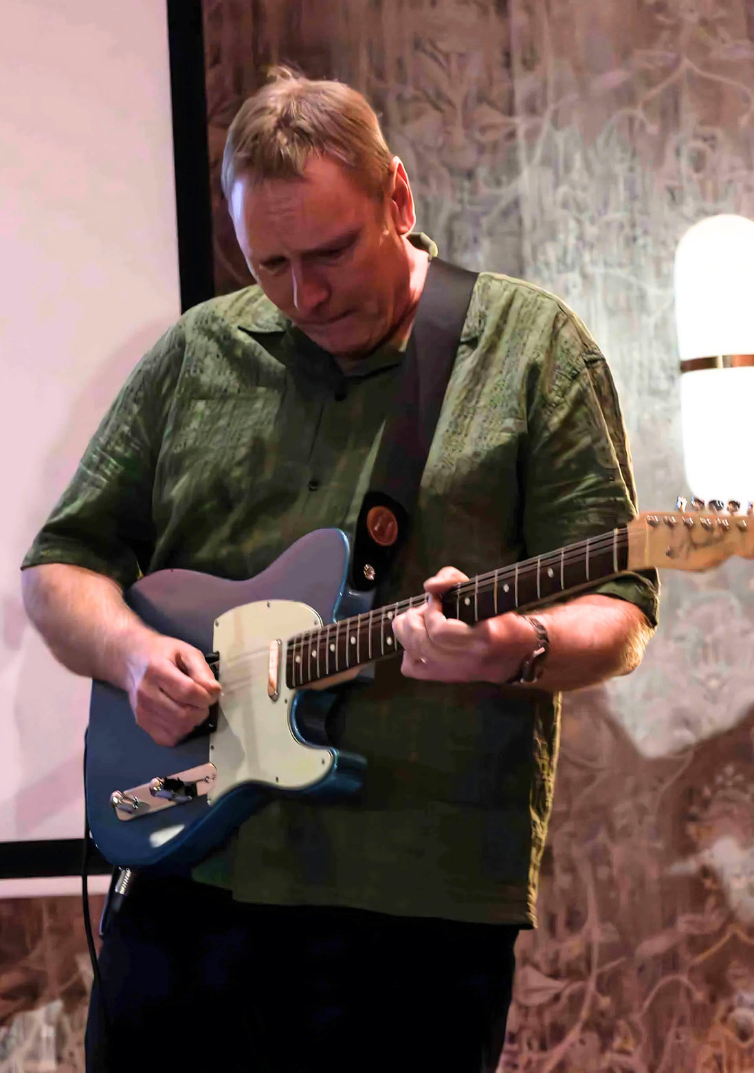 John Goldie playing guitar at Guitar Dreams