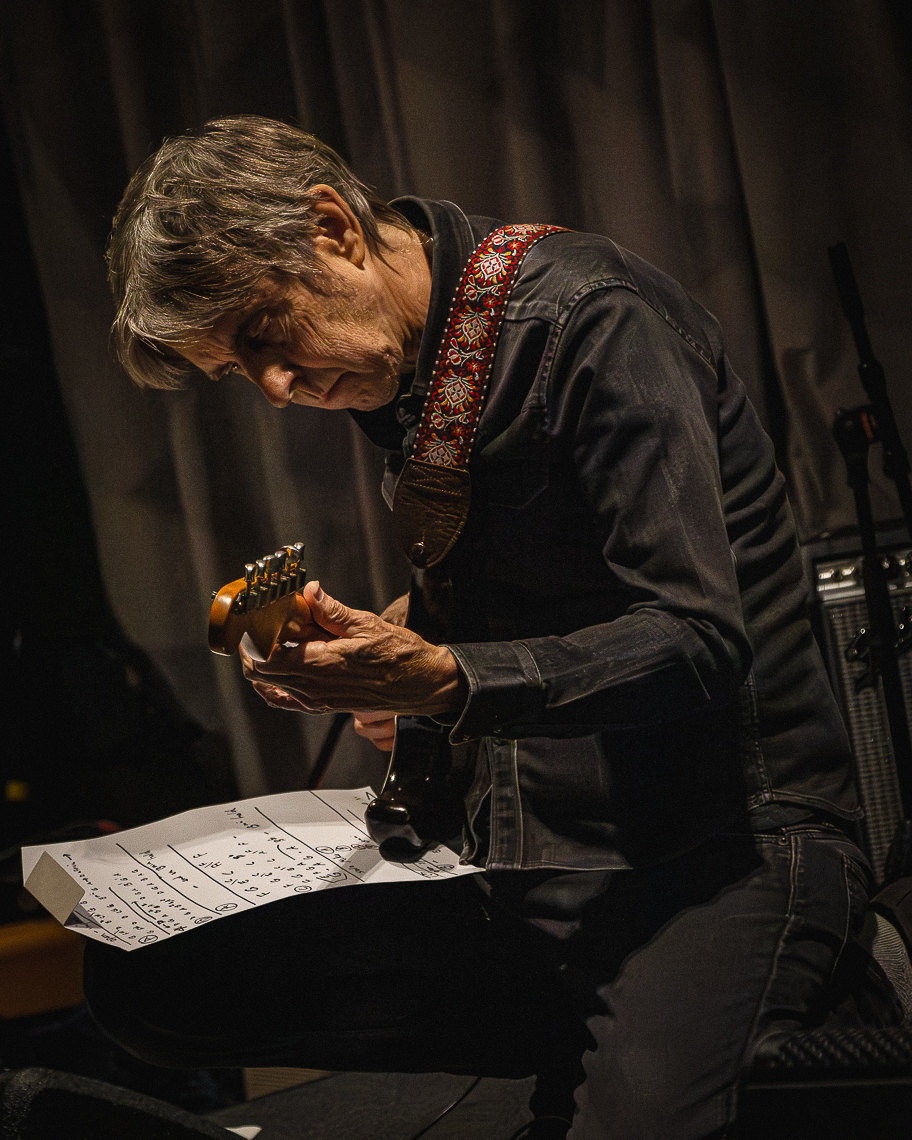A guitarist playing in the late-night jam