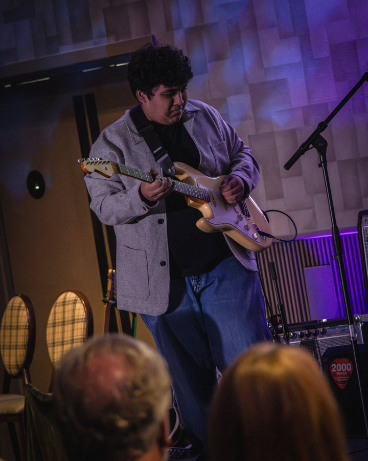 An artist performing under stage lights