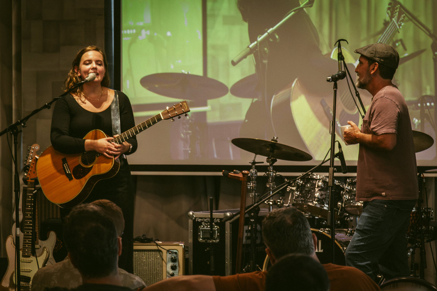 Mary Spender playing acoustic guitar in her songwriting workshop