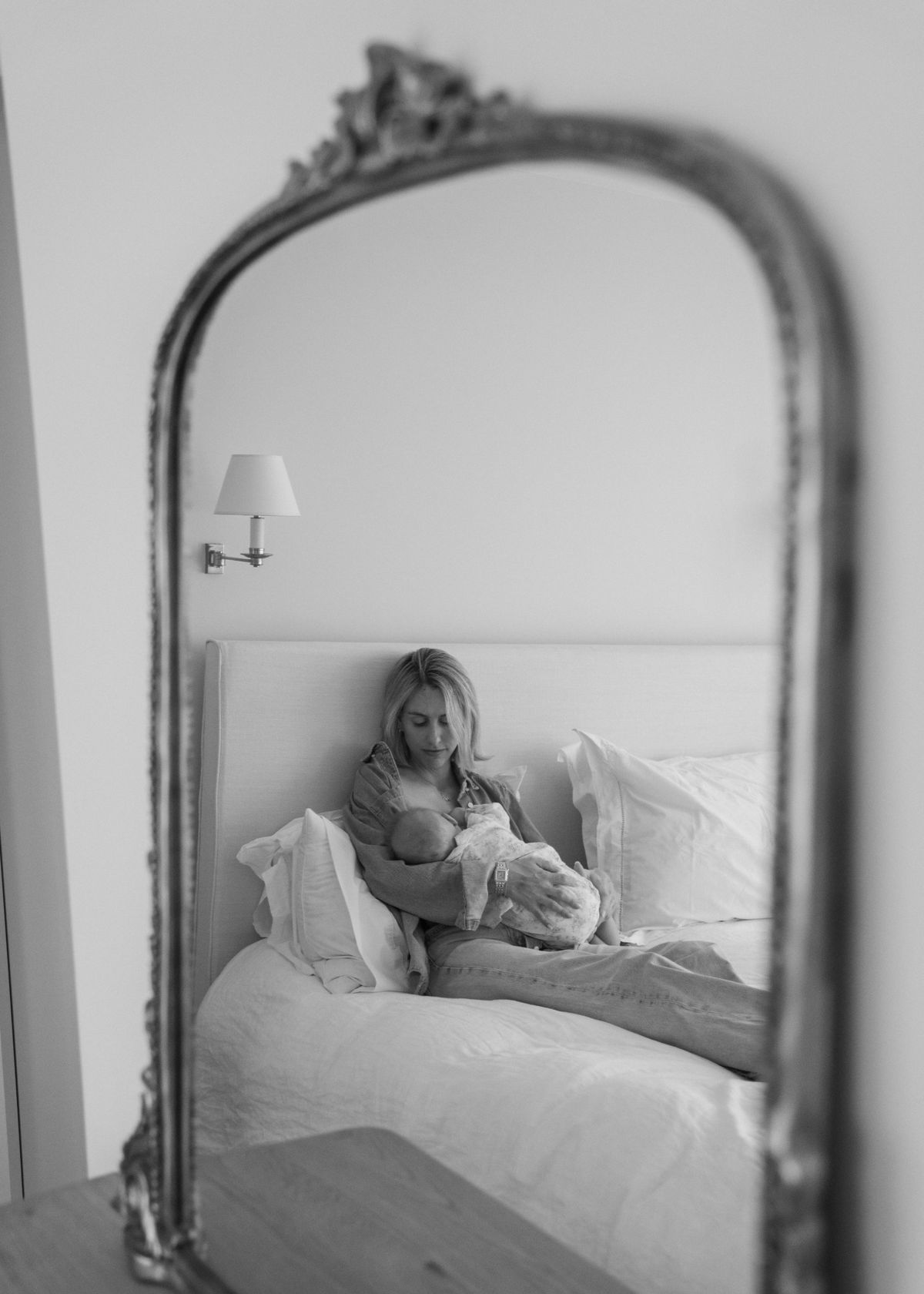 Carmela feeding her baby, reflected in a mirror