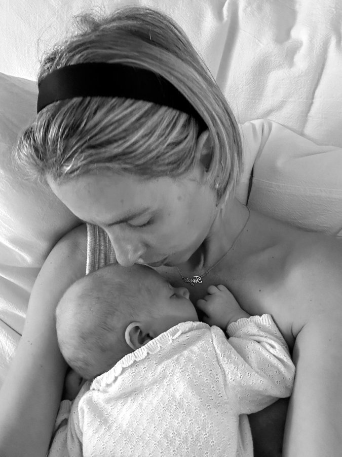 Carmela with her newborn on her chest