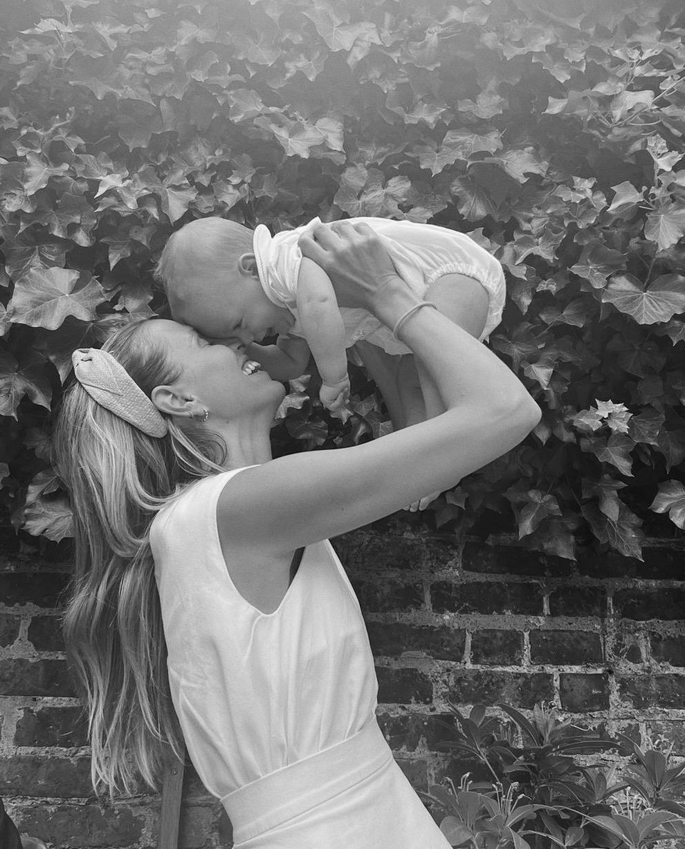 Carmela lifting her baby