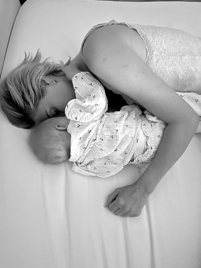 Carmela cuddling her baby