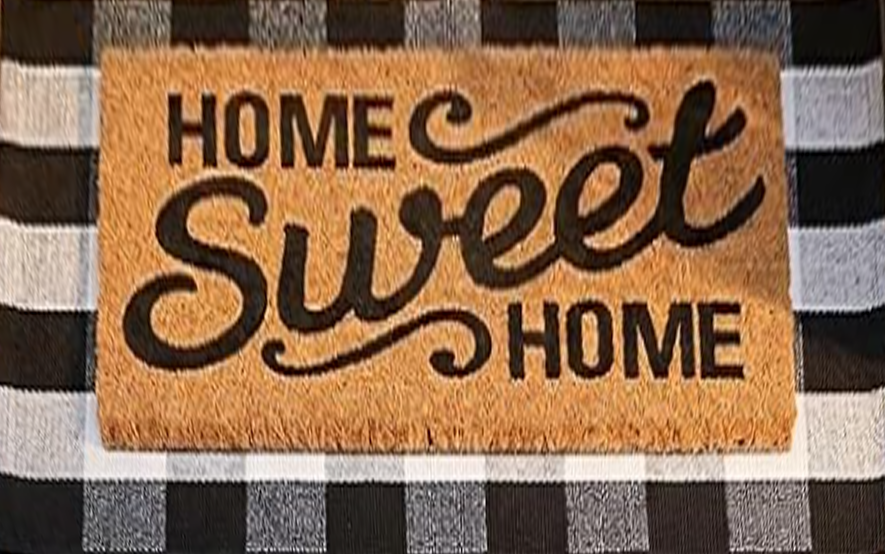 Home Sweet Home coir doormat layered on a black and white buffalo check rug