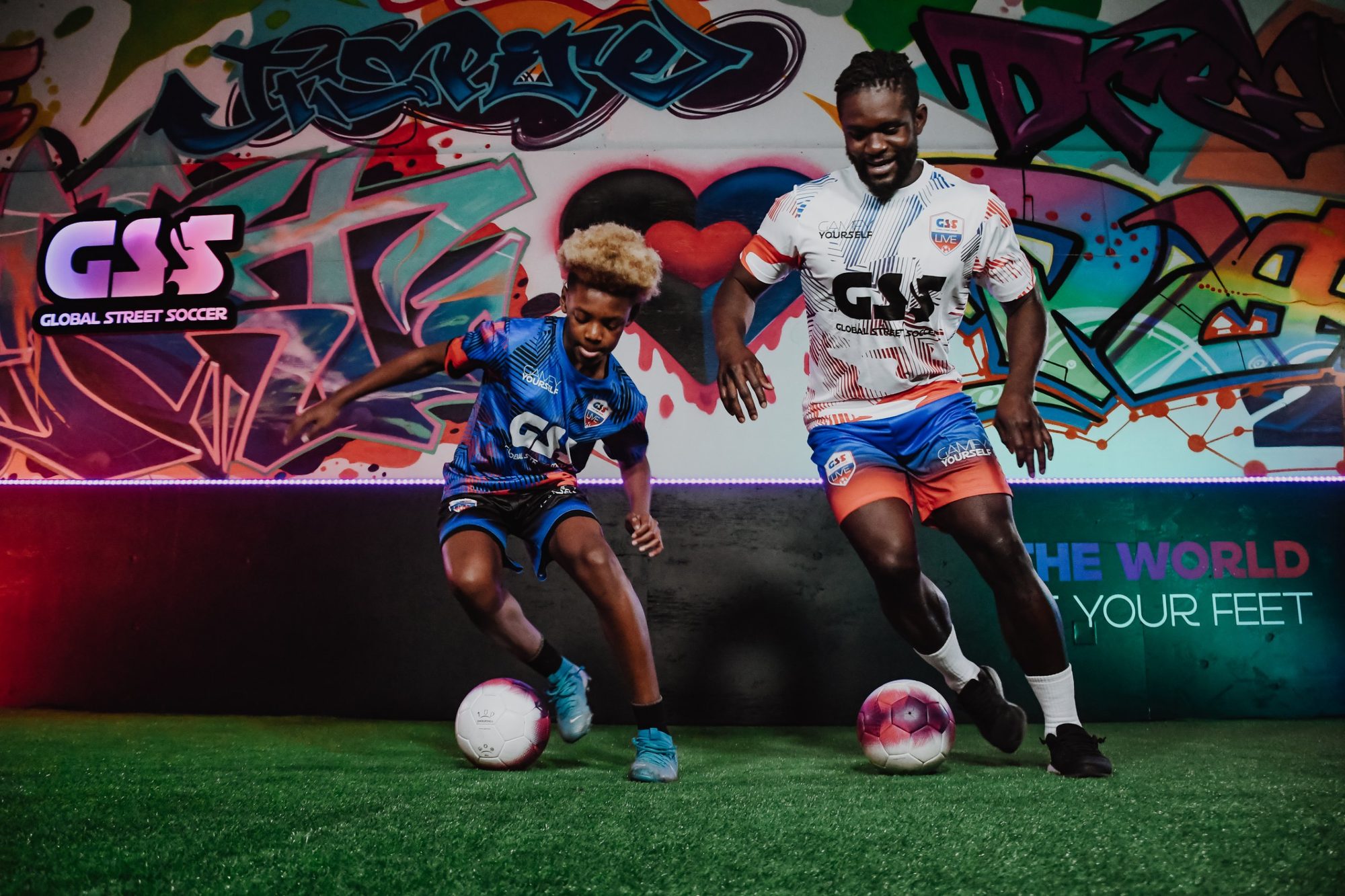 Coach Danny and a player dribbling together