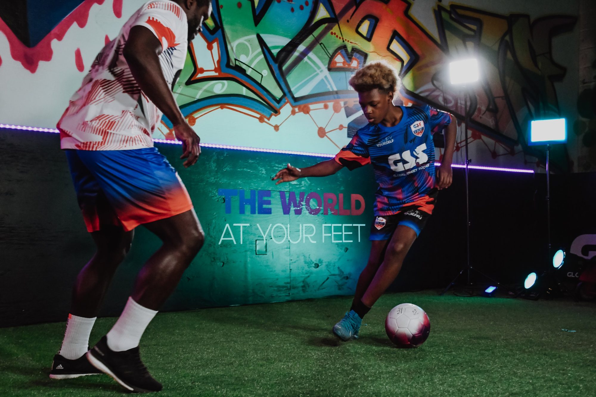 Coach Danny playing 1v1 with a young player in the GSS studio