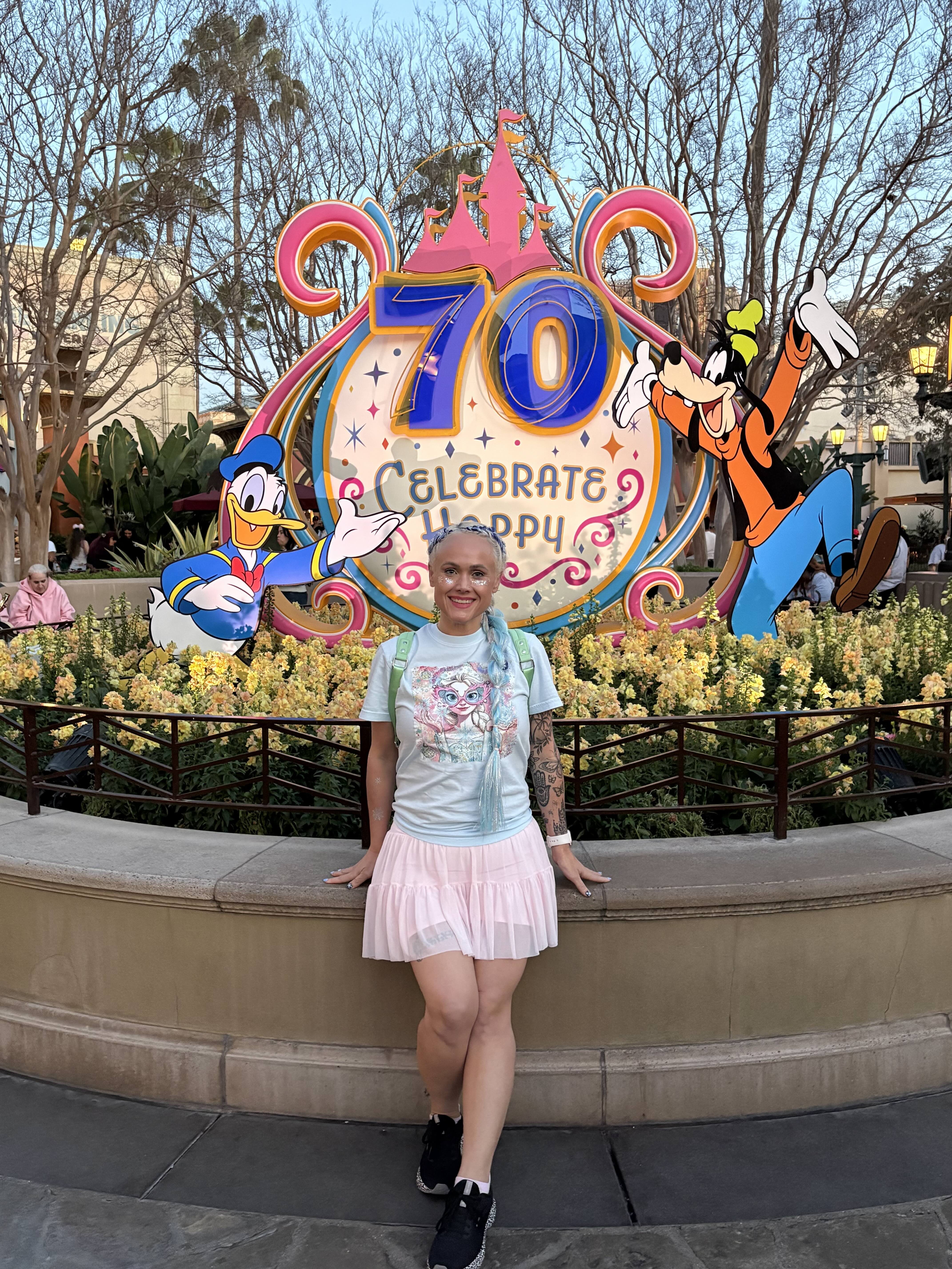 Myranda smiling in a light blue tee and pink skirt