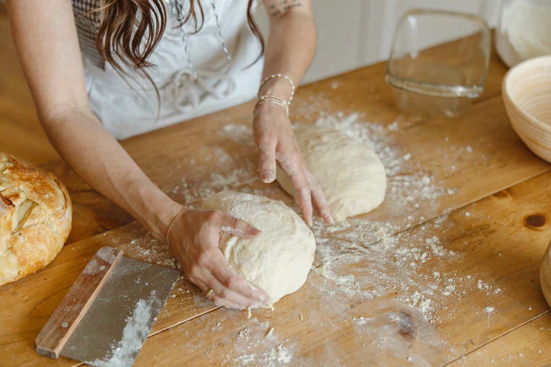 Kneading bread dough on a wooden counter